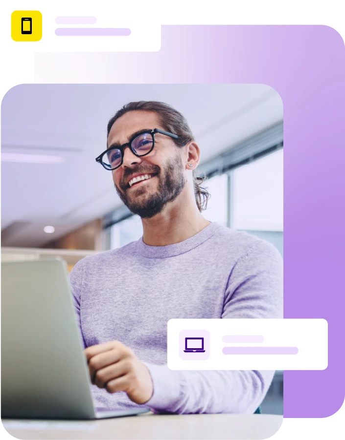 Smiling man with laptop on desk