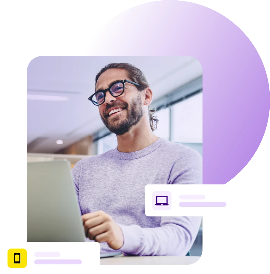 Smiling man with laptop on desk