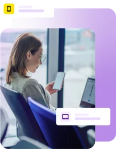Lady sat at an airport using a laptop and mobile phone