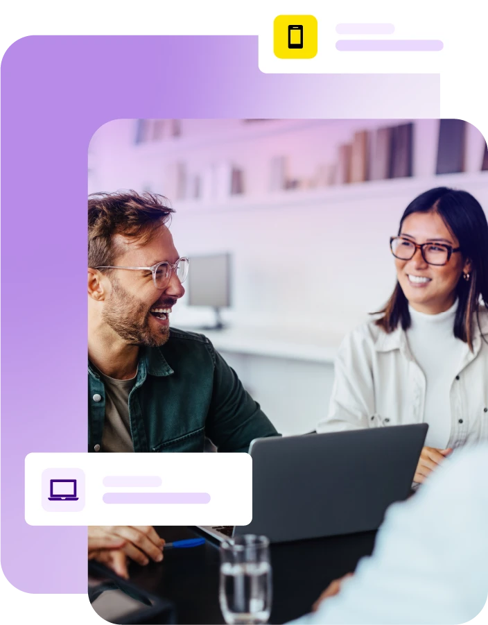 Man and lady smiling during a meeting with laptop on table