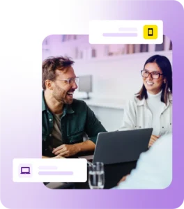 Man and lady smiling during a meeting with laptop on table