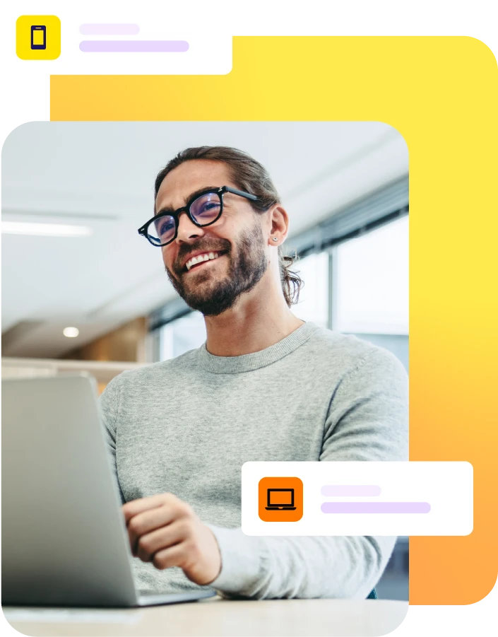 Smiling man with laptop on desk