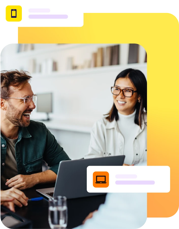 Man and lady smiling during a meeting with laptop on table